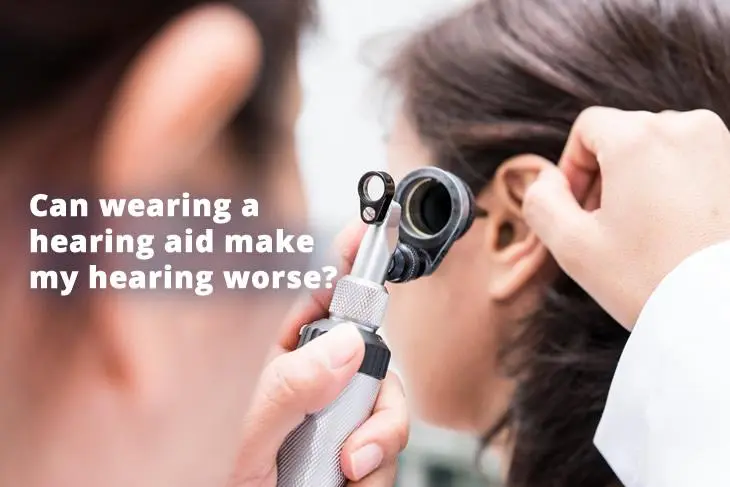 Hearing aids and doctor checking patients ear