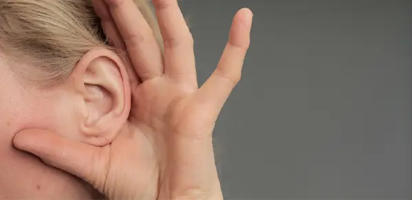 woman cupping her ears